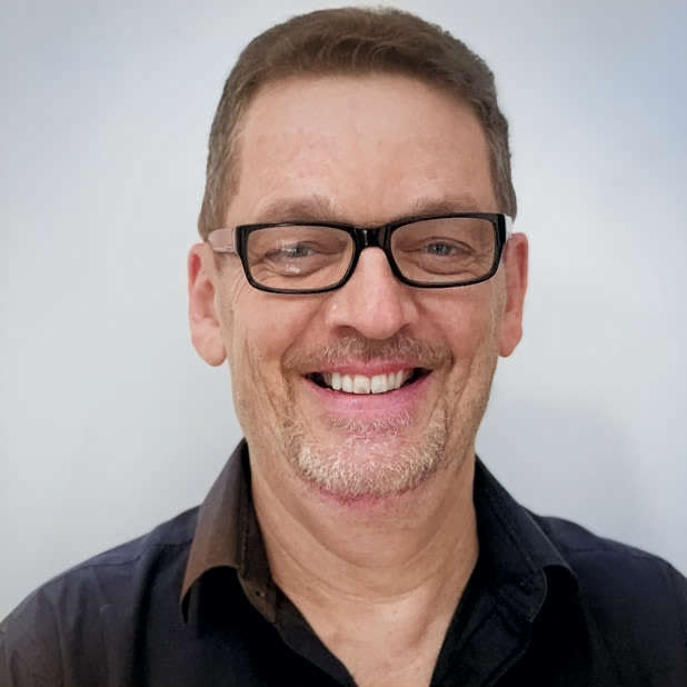 A smiling man wearing glasses.